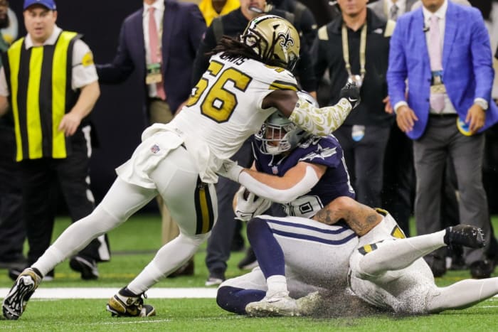 New Orleans Saints linebacker Demario Davis (56) tackles Dallas tight end Dalton Schultz (86). Mandatory Credit: Stephen Lew-USA TODAY Sports